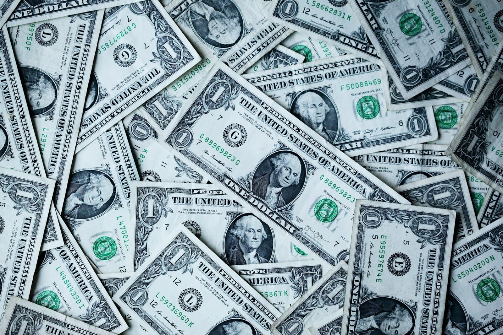 Dollar bills spread out flat on a surface