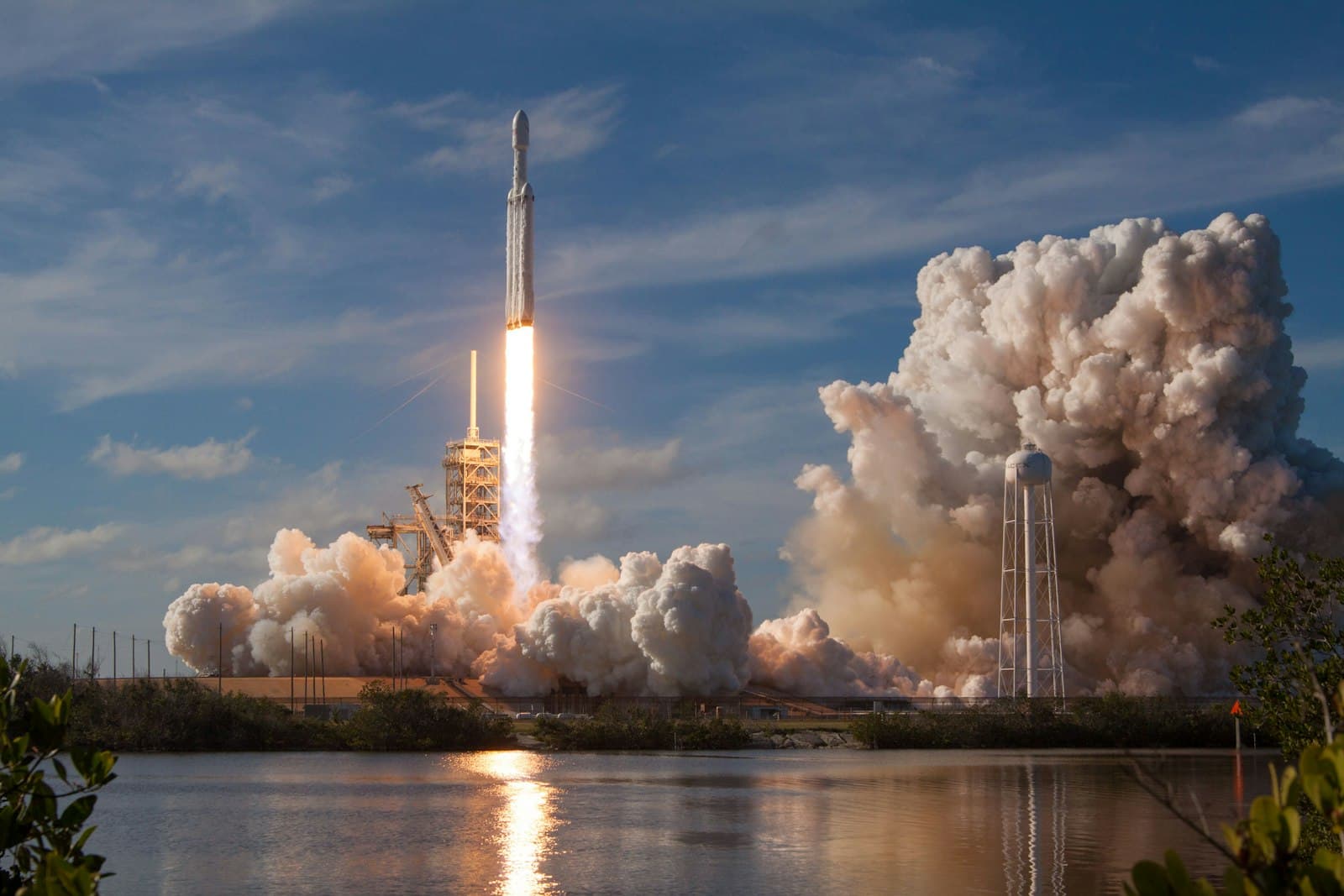 A rocket lifting off from the launch pad in a cloud of smoke