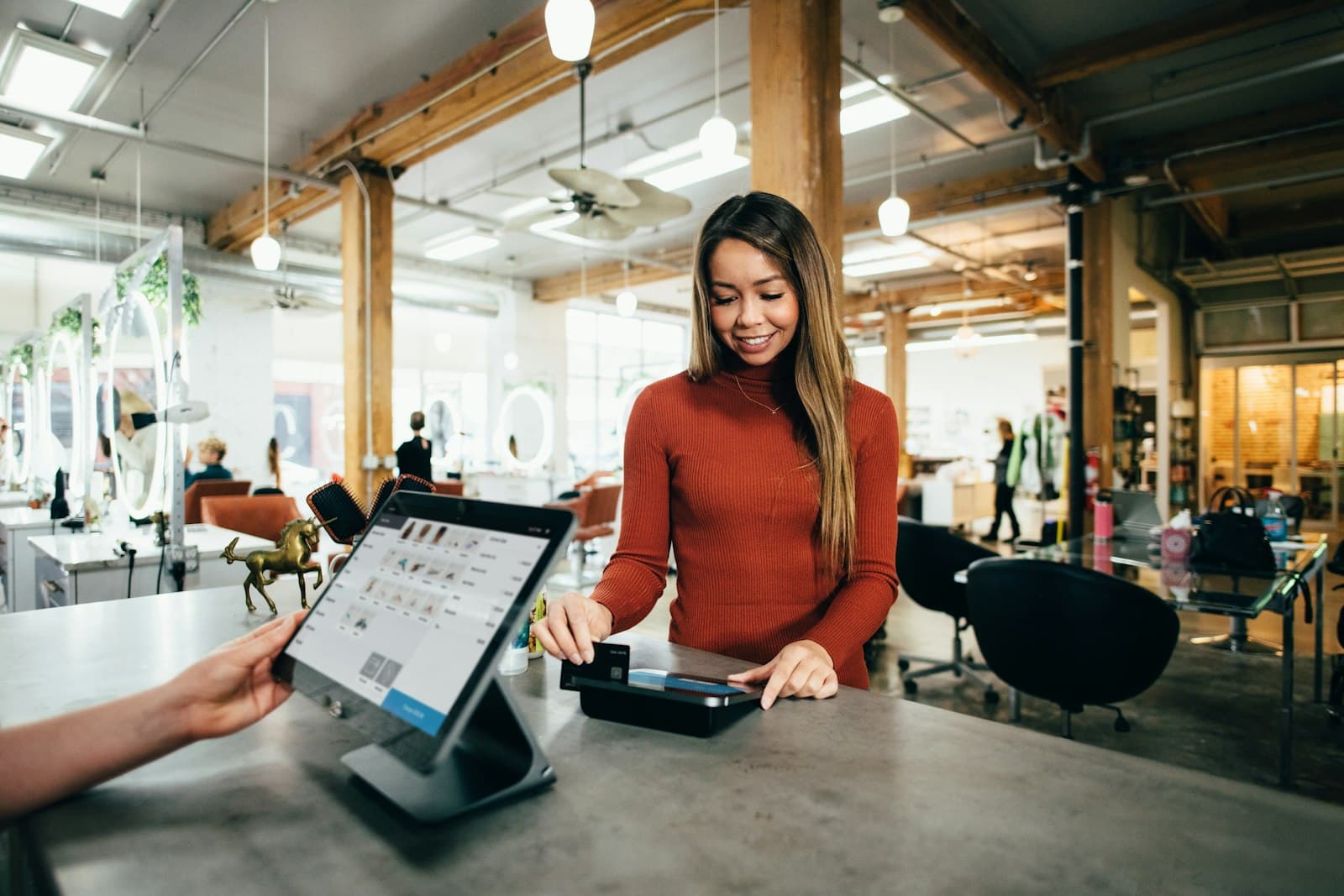 A customer paying with a card at a cafe counter